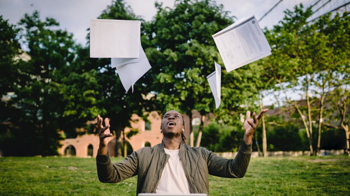excited african american male student celebrating successful results of exams