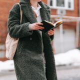 crop student reading book in winter town