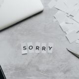 sorry text in pieces of white paper