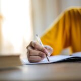 selective focus photo of person writing