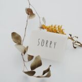 white postcard with sorry message