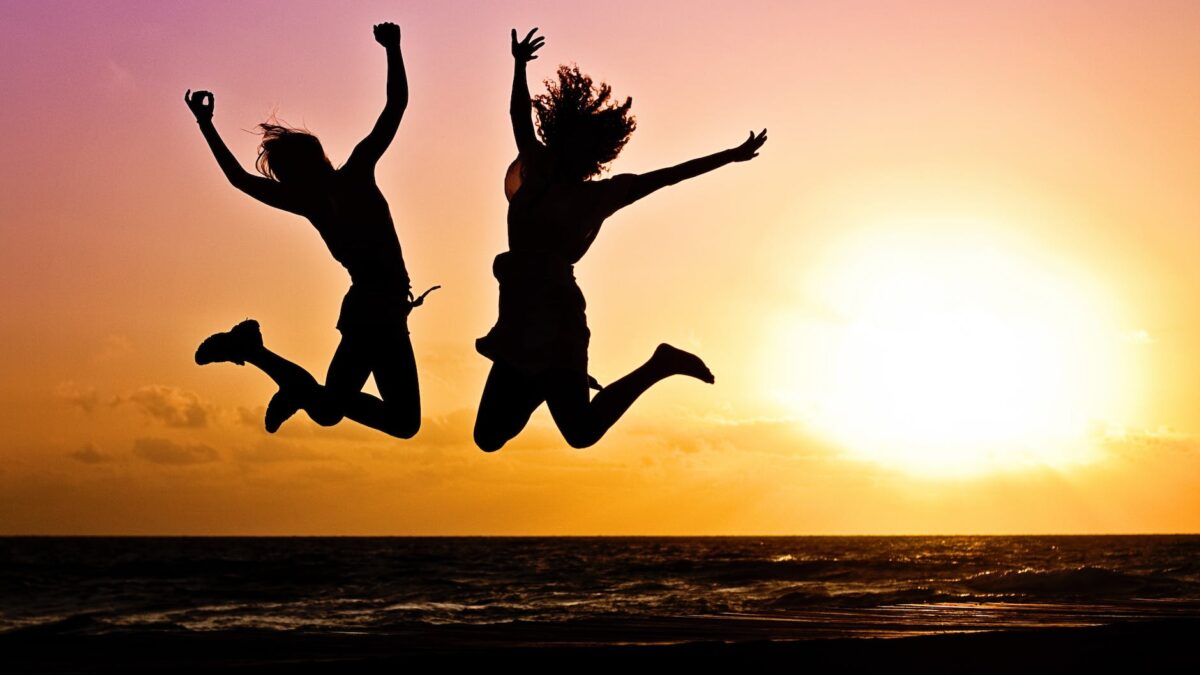 silhouette photography of jump shot of two persons