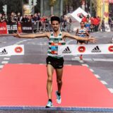 man running on black asphalt road