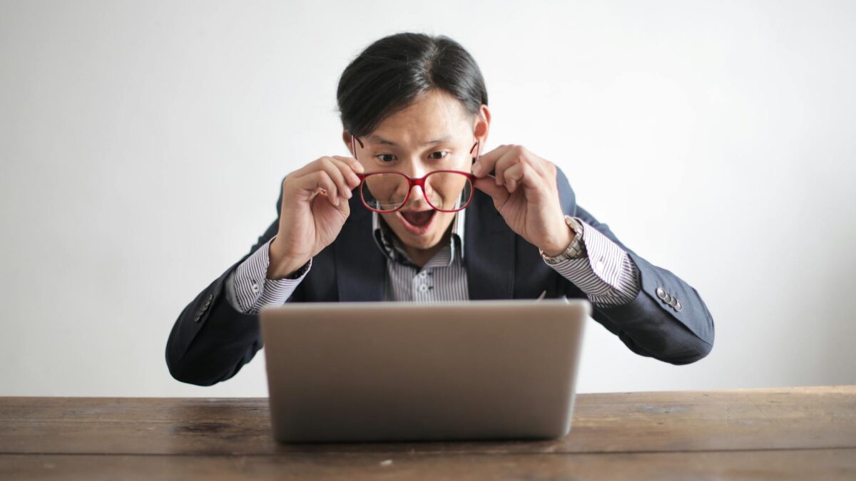 amazed formal male looking at laptop screen