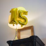 gold number balloons on top of the table