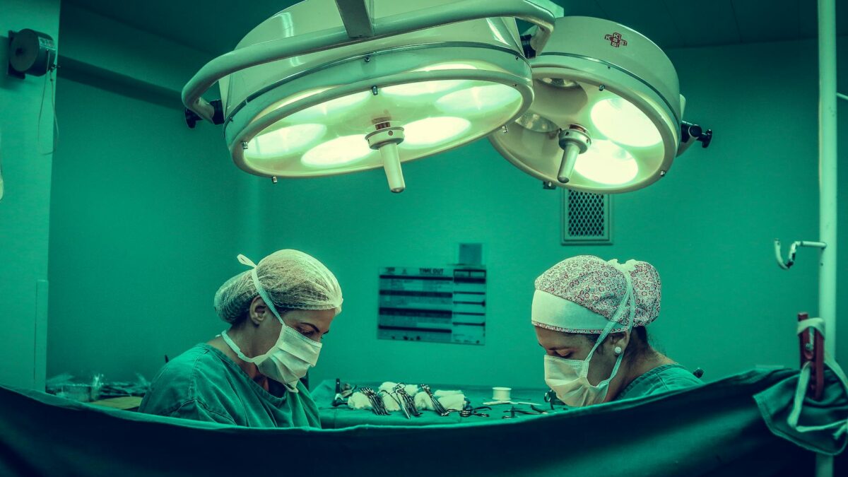 two person doing surgery inside room