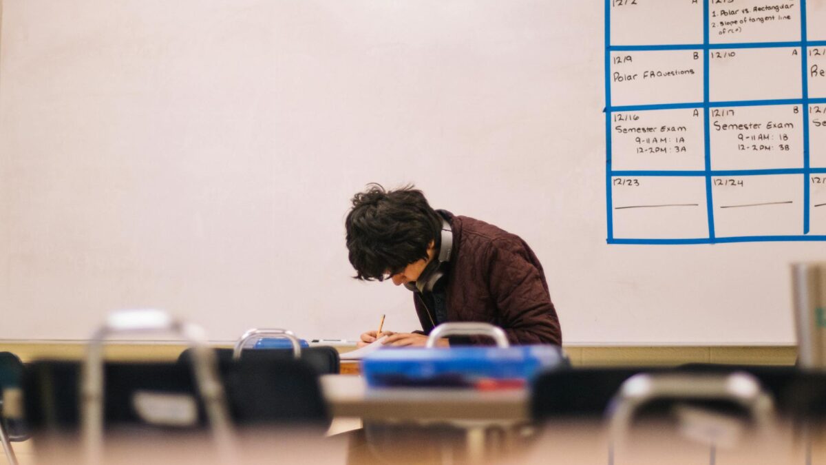 man writing on table