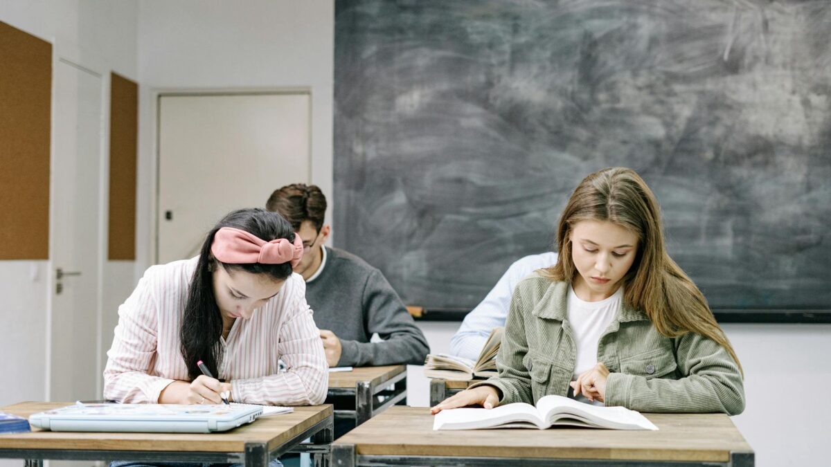 students sitting by the table in the classroom