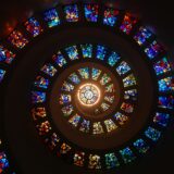 worms eye view of spiral stained glass decors through the roof