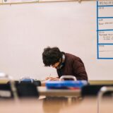 man writing on table