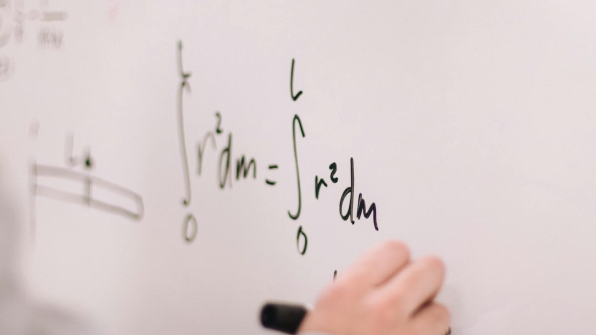 person writing on white board