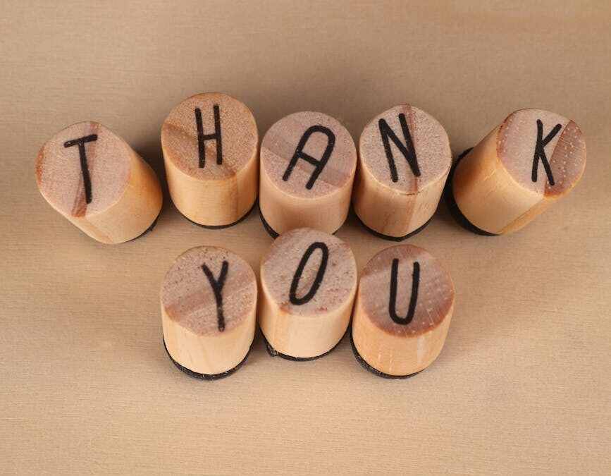 wooden block thank you message on beige background