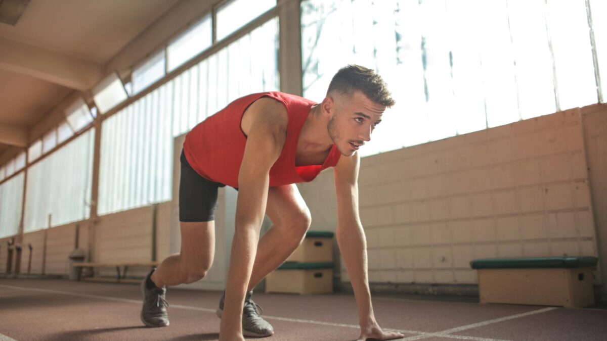 man in red tank top is about to run
