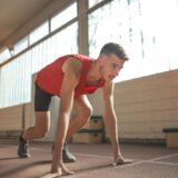 man in red tank top is about to run