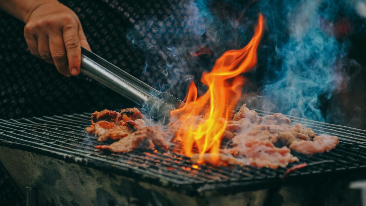 close up photo of man cooking meat