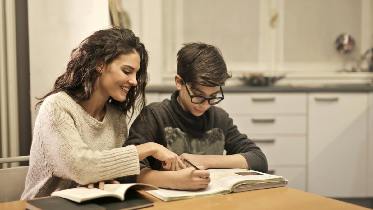 elder sister and brother studying at home