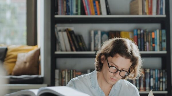 a diligent male student reading a book