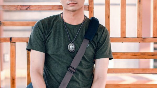 man standing near brown wooden frame