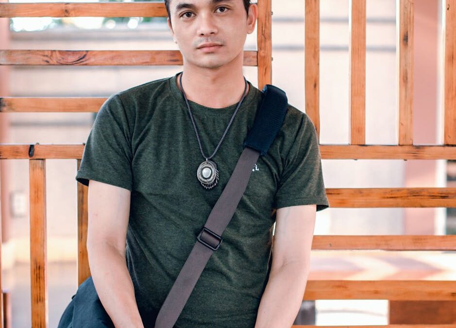 man standing near brown wooden frame