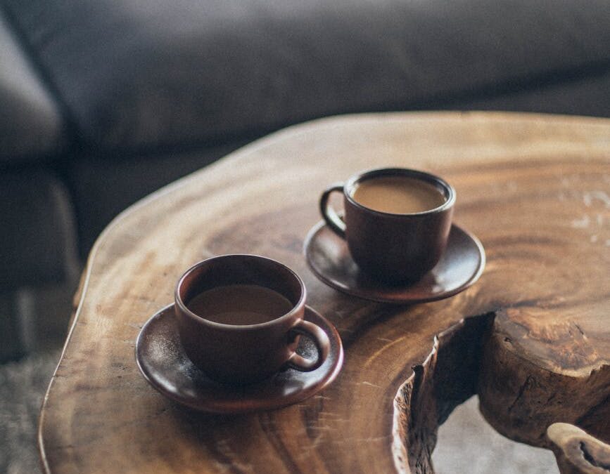 two brown ceramic mugs