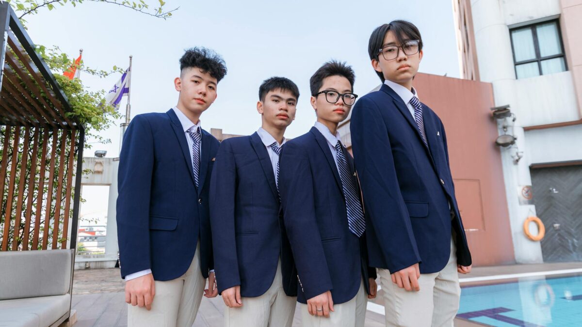 four schoolboys in elegant uniforms